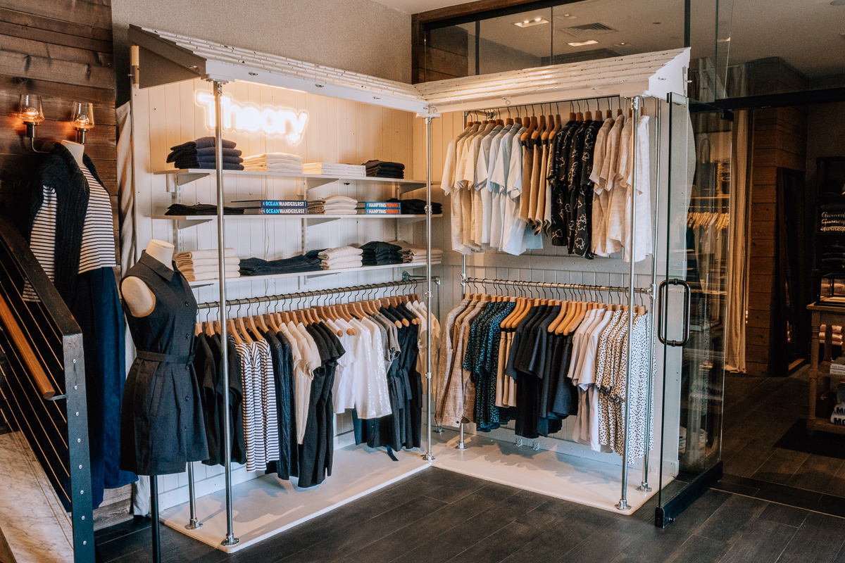 A pop-up shop from Theory at Gurney's Montauk Resort, displaying clothes on racks and hanging on the wall.