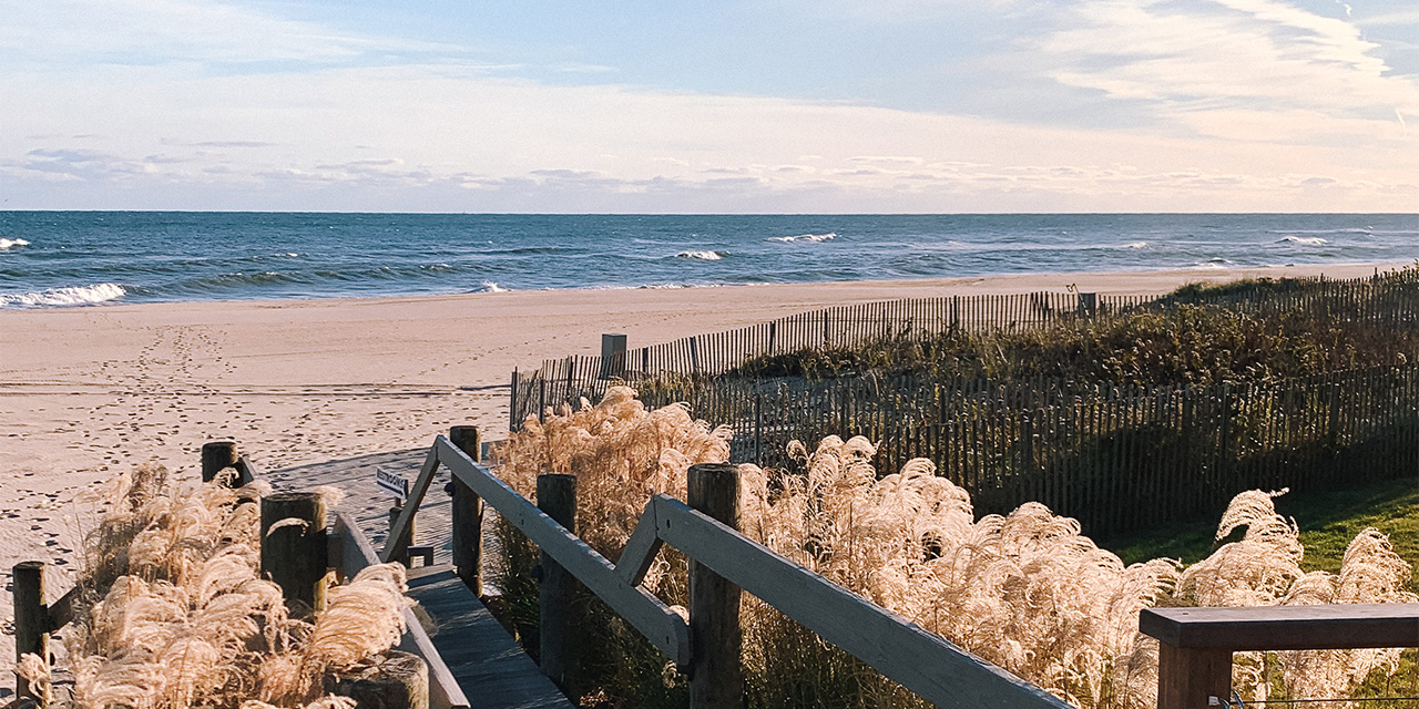 A boardwalk leading to the beach is framed by winter grasses at Gurney's Montauk Resort