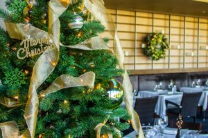 Praying Monk Dining Room decorated with Christmas tree, reefs and other holiday decor. 