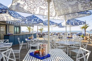 Table with blue and white umbrellas