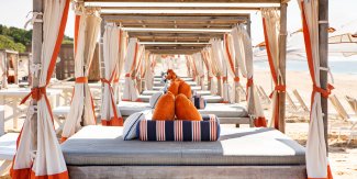 a row of private beach cabanas