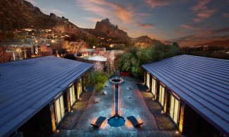 View of Sanctuary Spa's Zen Garden and in-door/out-door treatment rooms at dusk.