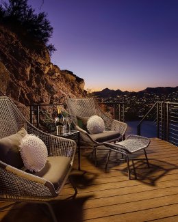 Villa Ventana guest house patio with seating area at dusk.